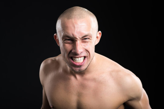 the man clenches his teeth in anger, angry look, frustrated, outraged or annoyed, screaming no