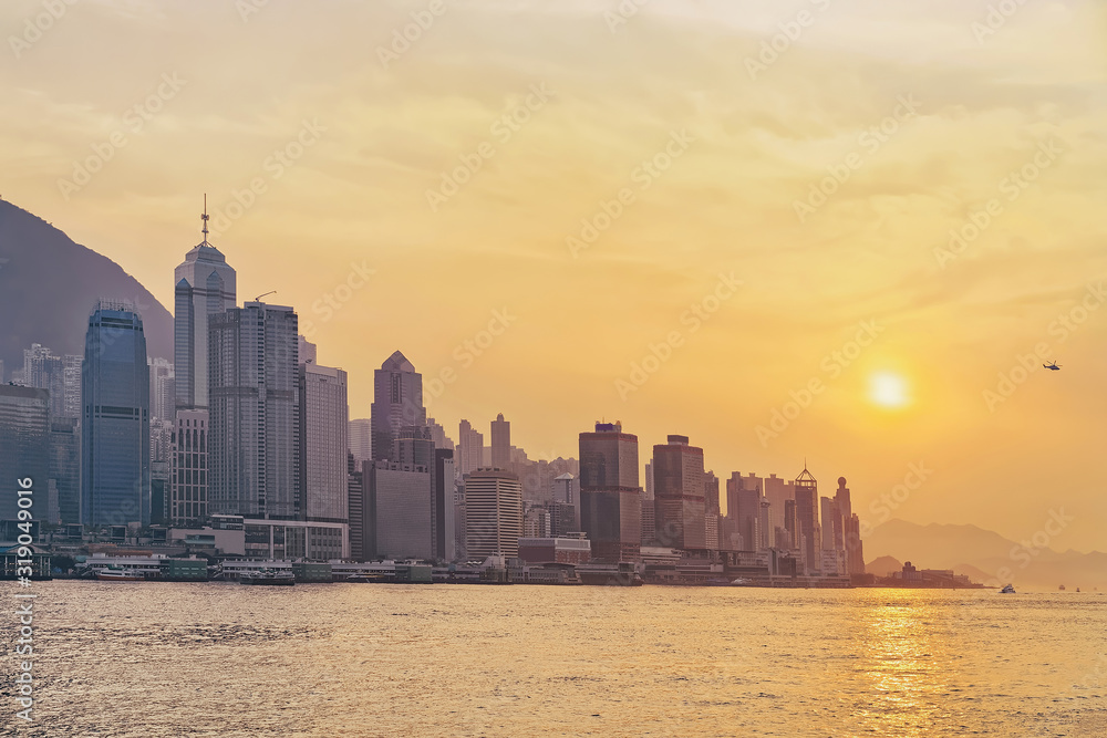 Wall mural beautiful victoria harbor of hong kong at sunset. view from kowloon on hk island.