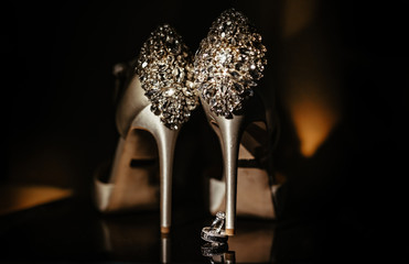 Luxurious White Gold Diamond Engagement Ring Next to Wedding Shoes Bride. Wedding Details
