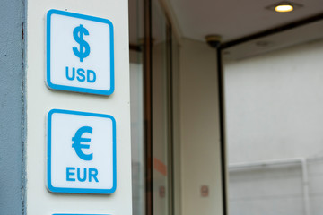 Dollar and euro signs. Written in blue on white signboard.