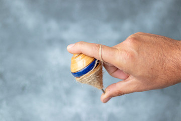 Classic wooden spinning top toy with string