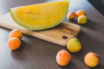 yellow watermelon on cutting board on kitchen top