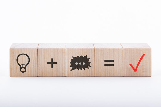 Top wooden blocks with the image of light bulb, message and notes. Business success and concept creation idea.