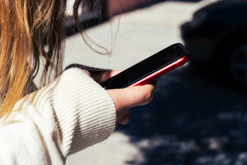 Mujer sostiene teléfono inteligente rojo