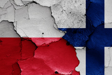 flags of Poland and Finland painted on cracked wall
