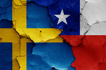flags of Sweden and Chile painted on cracked wall