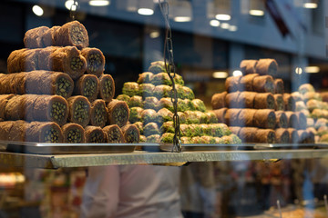 Traditional fresh baklava with pistachio nuts, pyramid shop display.
