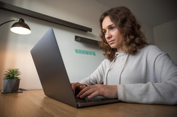 Business woman, young woman working on a computer, sitting at a desk in a modern office