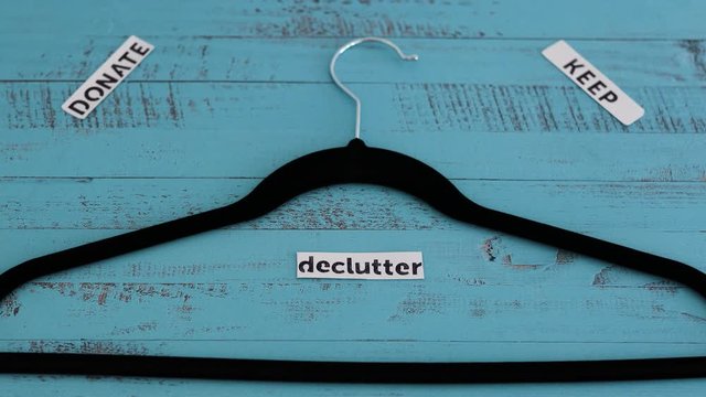 clothes hanger with text labels to sort between objects to keep donate or declutter