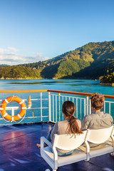New Zealand Cruise ship ferry travel couple tourists relaxing enjoying sunset view of Cook Strait,...