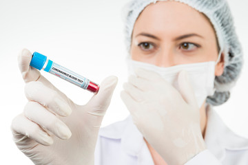 Nurse holding protective mask with positive result in the blood test of the widely spread coronavirus.