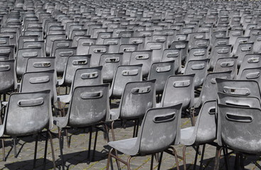 
Gray and black chairs in a row on the square