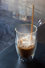 Iced coffee in coffee shop on wooden table