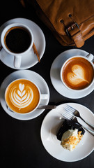 Hot coffee cups with beautiful latte art  on table in coffee shop, selective focus for background