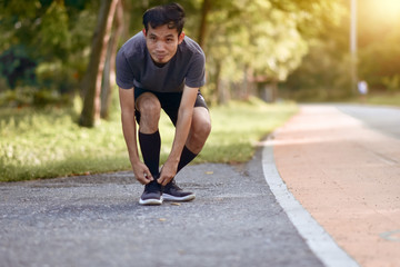 Asian Runner man running in city park morning outdoors