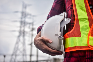 Close up hand holding white helmet hard hat Engineering concept