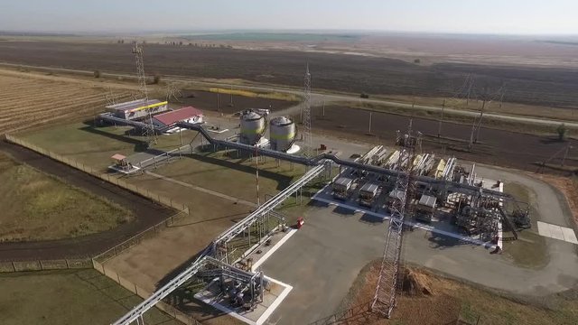 aerial view of transporting station of petroleum plant with flare stack in field