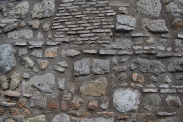  Part of an uneven stone wall with cement. Background, texture