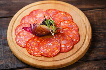 Delicious meat snack, menu photo, luxury restaurant meals. Salami served on wooden board