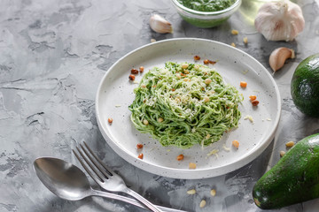 Green pasta with avocado, spinach and pine nuts