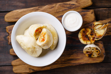 Vareniki dumplings, pierogi. Traditional Ukrainian food. Cooked and served with sour cream vareniki, pyrohy or dumplings, filled with potato