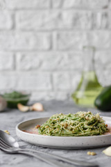 Green pasta with avocado, spinach and pine nuts
