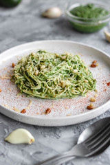 Green pasta with avocado, spinach and pine nuts