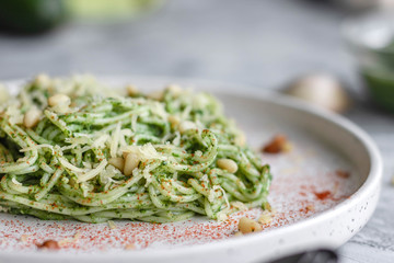 Green pasta with avocado, spinach and pine nuts