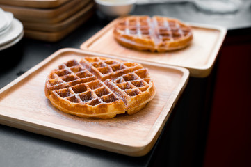 waffles with butter on wooden plate