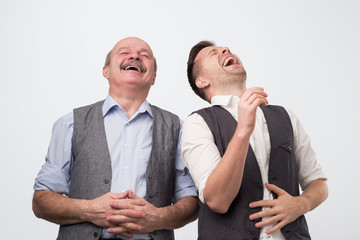 Two caucasian men laughing on his friends joke - obrazy, fototapety, plakaty