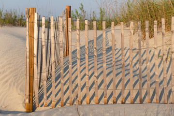 A typical wooden fence along the barrier sand dunes designed to keep tourists and children away...