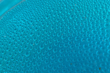 Blue water drops background close up