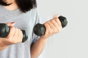 Fototapeta na wymiar healthy Asian woman doing exercise lifting dumbbell with two hands 
