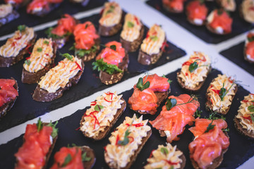 Beautifully decorated catering banquet table with variety of vegetables and different vegan vegetarian snacks on corporate christmas birthday party event or wedding celebration