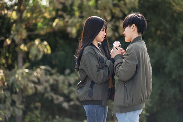 A couple of LGBT Lesbian holding hands each other while smiling with happiness. Same sex young married female couple Concept..