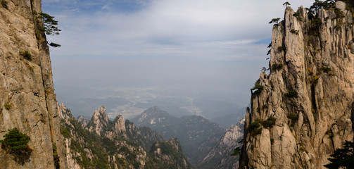 Crack at Beginning to Believe Peak on Huangshan Mountain with villages in the valley China