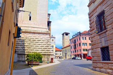 historical part of the old town square with a tower and a building with a dial
