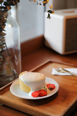 strawberry cream cake on wooden tray