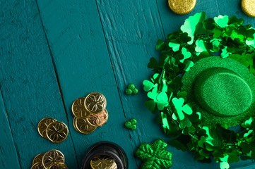 Traditional Irish holiday St. Patrick's Day, March 17th celebration, with accessories for teething on a green wooden background.