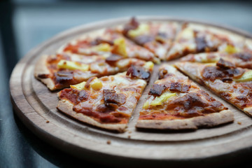 Hawaiian pizza , pizza with ham bacon pineapple in wooden plate