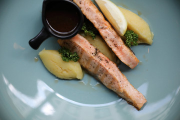 Roasted salmon steak , baked salmon with salad fresh vegetable in restaurant