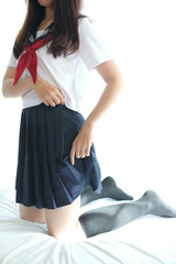 Naklejka premium Portrait japanese school girl in white tone bed room