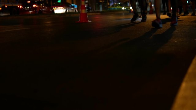 People running marathon on the road at night