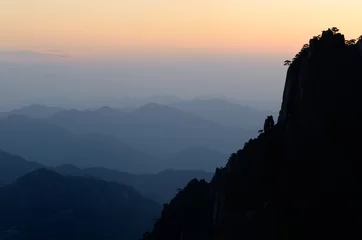 Papier Peint photo Monts Huang Receeding peaks at West Sea from Cloud Dispelling Pavilion at dusk on Huangshan Yellow Mountain China