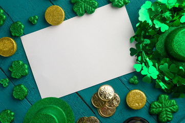 White postcard for design St. Patrick's Day celebration, on green wooden background, top view