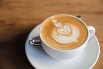 cappuccino or Latte art coffee made from milk on the wood table in coffee shop