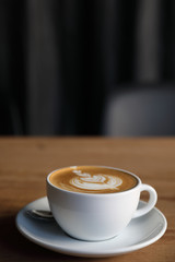 cappuccino or Latte art coffee made from milk on the wood table in coffee shop