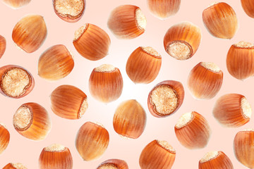 Colorful pattern of hazelnuts on pink milk background. Top view. Chocolate packaging cover
