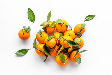 Tangerines with leaves on white background top-down
