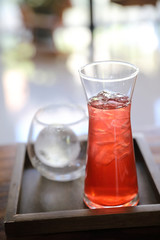 Strawberry iced tea on wood background